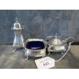 A three piece silver cruet complete with blue liners on four bun feet