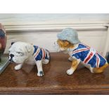 Two Carltonware figures of Bulldogs, both with a Union Jack colours, one wearing a helmet, 15cm