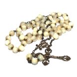 A mother of pearl bead rosary