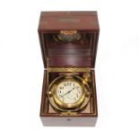 A Waltham Watch Co. brass deck watch in a brass gimbal and brass bound mahogany case, the silvered