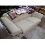 A three seat settee, with scroll arms and turned legs on brass caps and castors 213cm wide and an