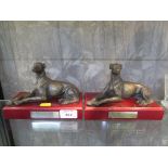 Two bronzed figures of resting greyhounds, 11.5cm high