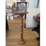 An oak framed table top dinner gong, with Corinthian columns, 25cm high and a spiral turned