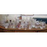 Various cut glass vases and decanters, butter dishes and other glassware, including some coloured