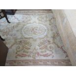 A European flatweave rug, the beige and ivory field with allover scrolls and rose garlands within