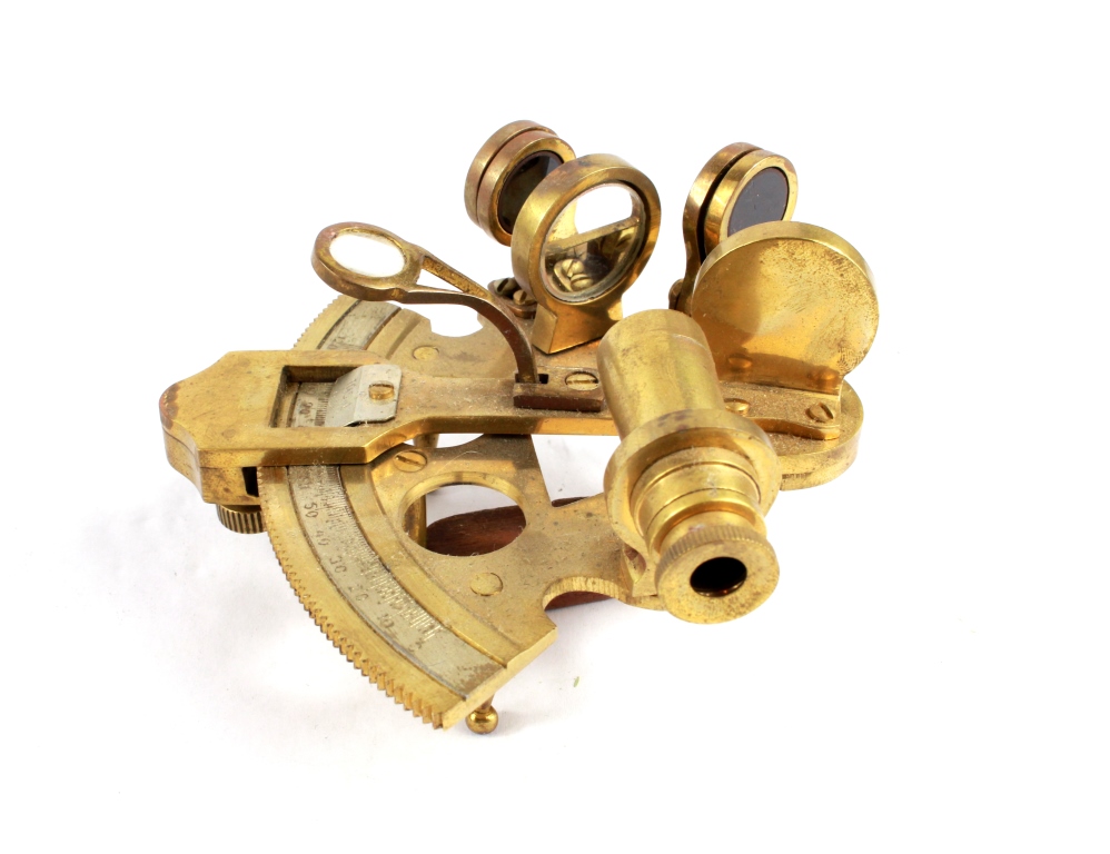 A brass miniature sextant, with filters, and 120 degree scale in a brass bound case 10.5cm long