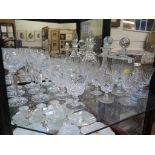 Four Stuart glass wine glasses, three Thomas Webb glasses, four glass decanters and other drinking