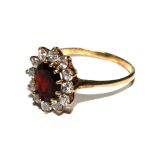 A garnet ring set in gold colour metal