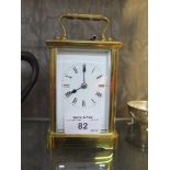 A brass carriage clock, of conventional form with white enamel dial and single train movement 14.5cm