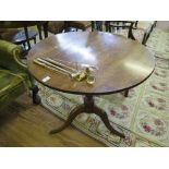 A George III oak tripod table, the circular snaptop on a baluster turned stem and cabriole legs,