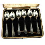An enamel spoon and five plated teaspoons and six plated coffee spoons