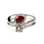 A ruby and diamond ring set in 18 carat white gold