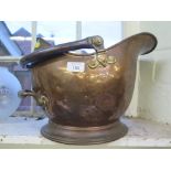 A copper coal helmet, and a brass and glass oil lamp (2)