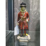 A painted metal table lighter in the form of a Yeoman of the Guard, 16.5cm high