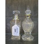 A pair of glass scent bottles with silver collars