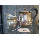 A bachelors silver tea pot together with a silver cream jug