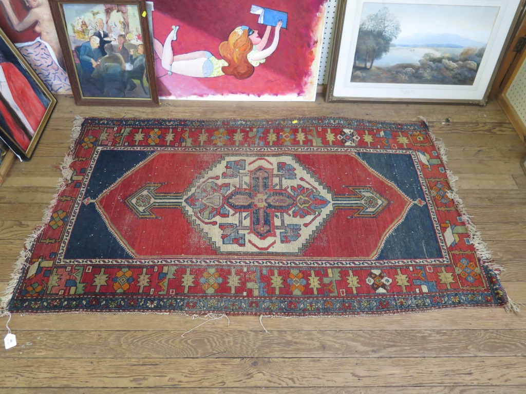 A Kazak rug, with ivory medallion on a red field with blue spandrels in a geometric border 170cm x - Image 2 of 2