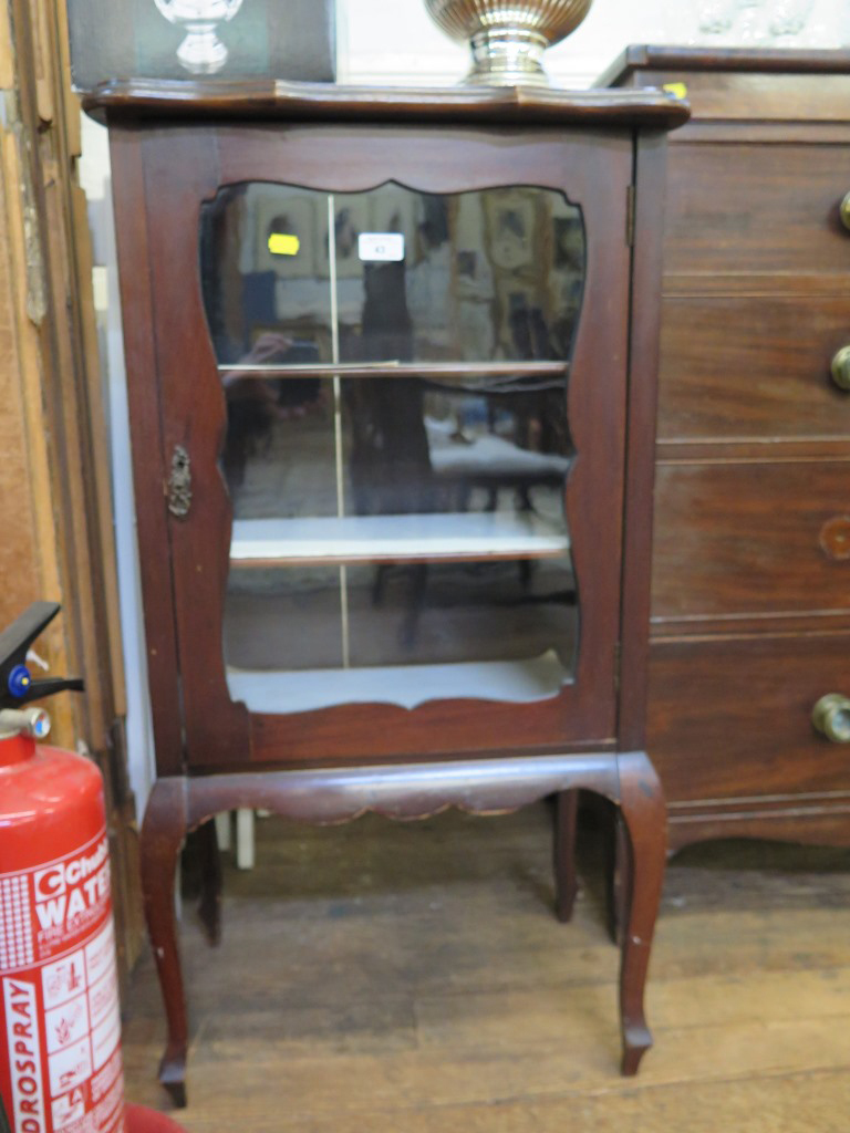 An Edwardian mahogany cabinet, with shaped top and glazed door on cabriole legs 53cm wide