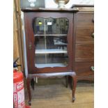 An Edwardian mahogany cabinet, with shaped top and glazed door on cabriole legs 53cm wide