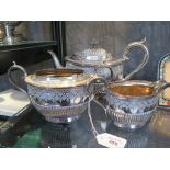 A silver plated four-piece tea-set including water jug