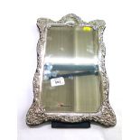 A silver rectangular embossed table mirror, with bevelled plate and velvet back, Carrs Sheffield