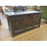 An 18th century oak coffer, the moulded hinged lid enclosing a later candlebox, the front with