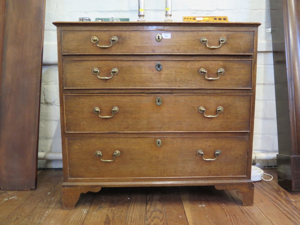 A George III oak chest of drawers, with four long graduated drawers on bracket feet, 91cm wide