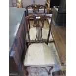 A pair of Edwardian stained beech bedroom chairs, with scrolled top rails, pierced waisted splats