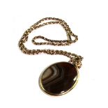 A banded agate pendant with 9 carat chain