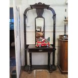 A late Victorian ebonised hall stand, with mirror back, frieze drawer and umbrella stands, 103cm