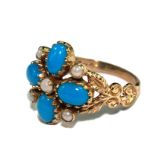 A reproduction turquoise and pearl ring set in 9 carat gold