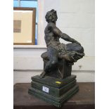 A bronzed ceramic figure of a male nude on a seat, 45.5cm high