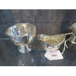 A small silver cream jug and a sugar bowl