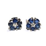 A pair of sapphire earrings with centre diamond
