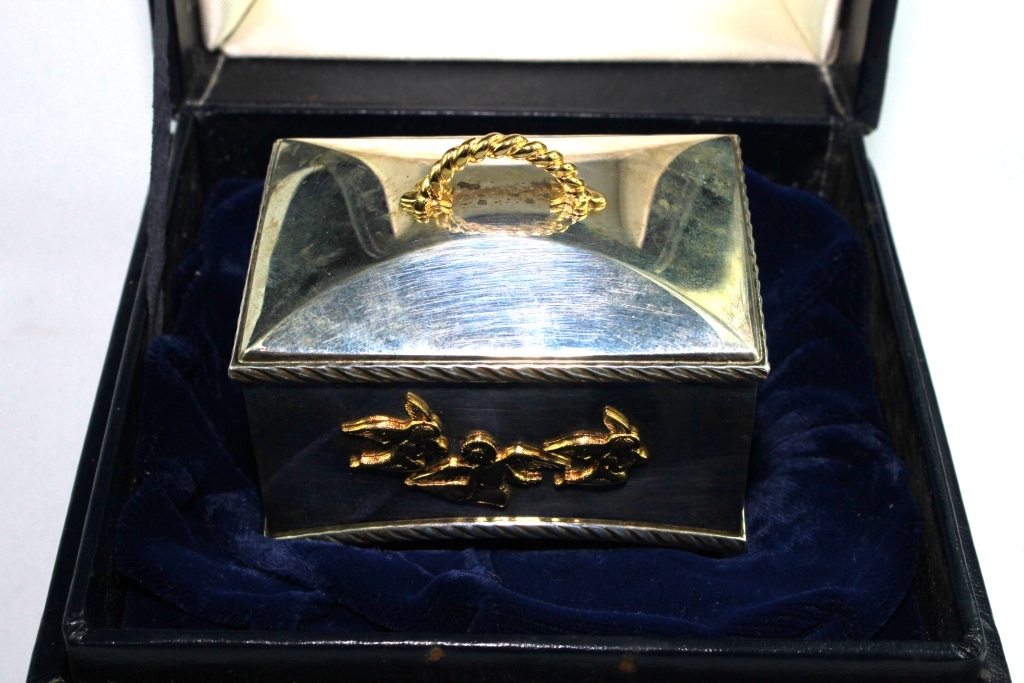 A silver and silver gilt music box from the St James House Company