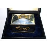 A silver and silver gilt music box from the St James House Company