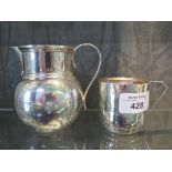 A substantial silver cream jug, Birmingham 1911 and a scrap silver cup