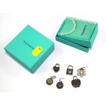 A pair of boxed Tiffany silver earrings together with four boxed Tiffany charms