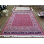 *A Bokhara style rug, on a red field within a multiple border 200cm x 292cm