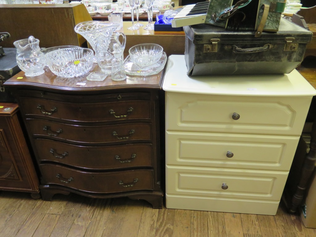 A reproduction serpentine crossbanded mahogany chest, with slide and four long graduated drawers,