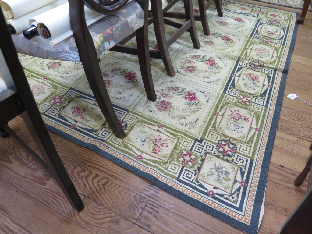 A European flatweave carpet, with 24 rose garland panels within a similar border 261cm x 190cm