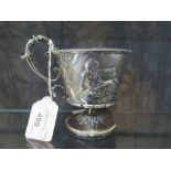 A Victorian silver goblet on single foot depicting in high relief two children at play, presentation