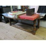 An oak dropleaf coffee table, the oval top on turned and block legs joined by stretchers 123cm wide