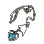 A blue heart shaped silver pendant and chain