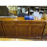 A Bevan Funnell Reprodux crossbanded yew-wood side cabinet, with three short drawers and three