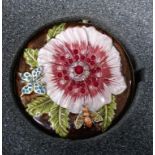 A ladies compact by Susanna Freud depicting a gem set flower, the compact comes in its original box