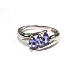 A 9 carat white gold ring set with tanzanites and diamonds
