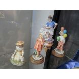 A porcelain model of a young girl in Spanish costume dancing on a low table together with three