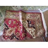 *A Heriz style rug, with red field, central medallion and sand spandrels, in a foliate scroll border
