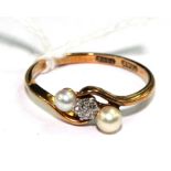 A pearl and diamond cross-over ring set in 18 carat gold